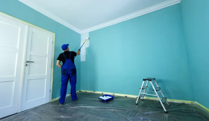 Brush Brothers painter carefully applying interior wall paint